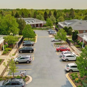 a parking lot with cars and trees