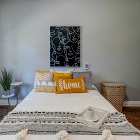 Bedroom with cozy pillows and nightstand