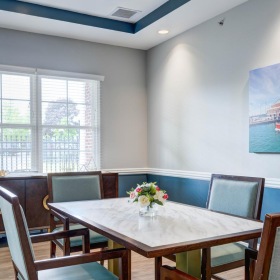 a dining room with a table and chairs