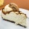 a slice of cake with whipped cream and a slice of lemon