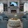a room with a fireplace and chairs