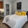 a bedroom with a bed and a chair